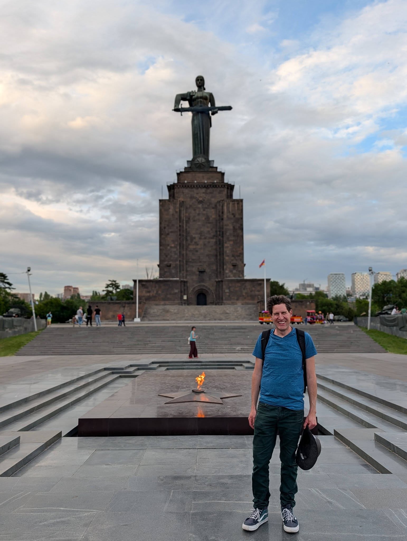 Eitan Feldman in front of a monumental statue